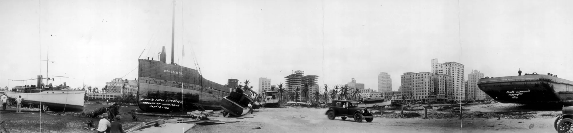 Miami after the 1926 hurricane - boats thrown ashore beside the road, buildings beyond