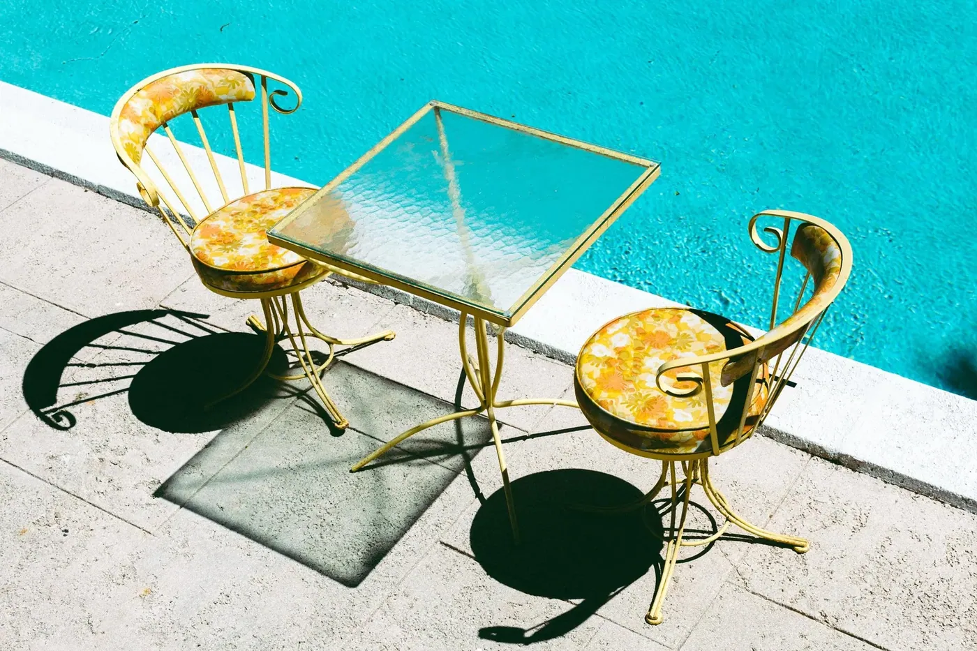 Pink chairs arranged beside the pool deck