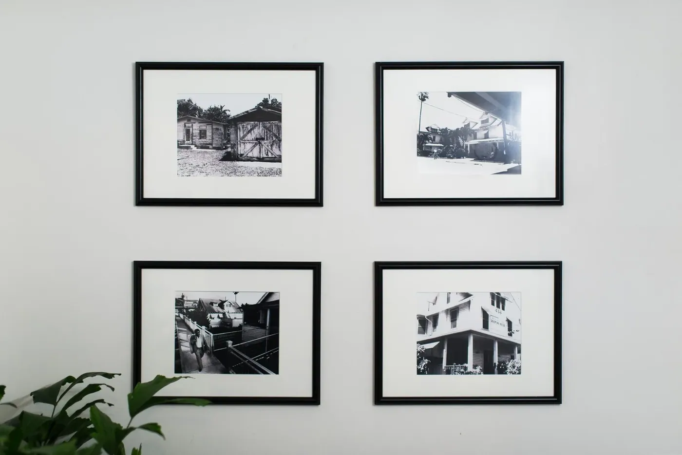 Framed photographs hung along an interior wall