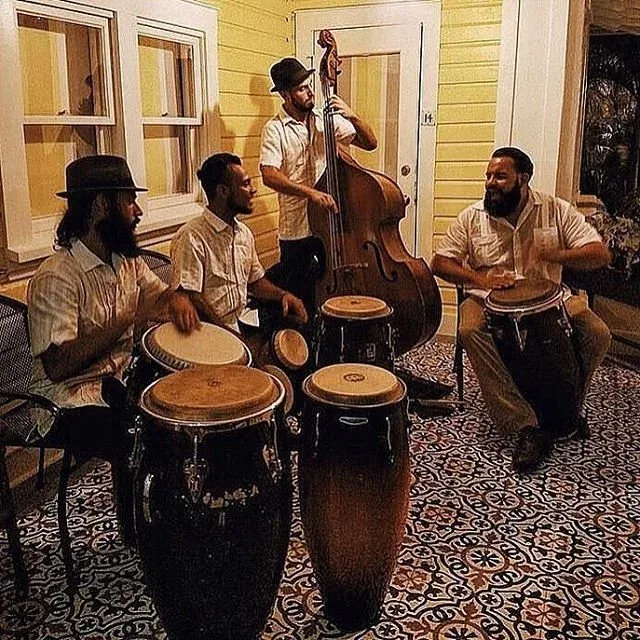 Percussionists playing on the porch at River House