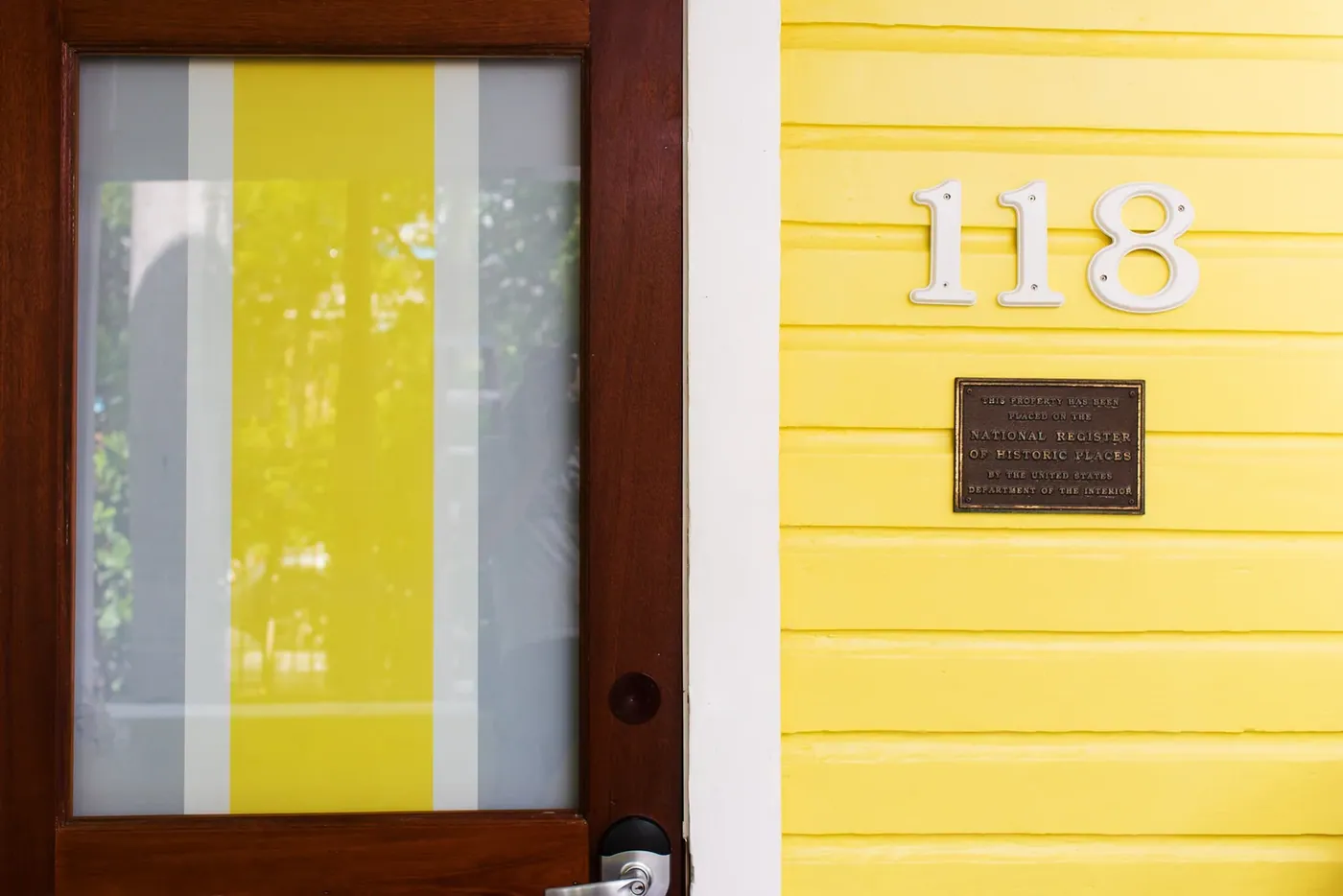 Painted door number 113 on the yellow cottage
